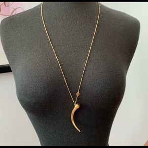 Tory Burch Gold horn pendant necklace.
